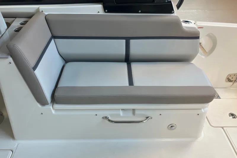 Slide: The Image of 2026 Boston Whaler 330 Vantage boat seat, featuring gray and white cushioned upholstery. - 17
