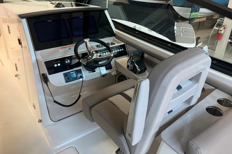 Slide: The Image of 2026 Boston Whaler 330 Vantage helm with modern controls and comfortable seating. - 19