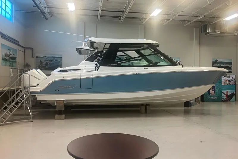 Slide: The Image of 2026 Boston Whaler 330 Vantage boat displayed indoors, showcasing sleek design and modern features. - 2