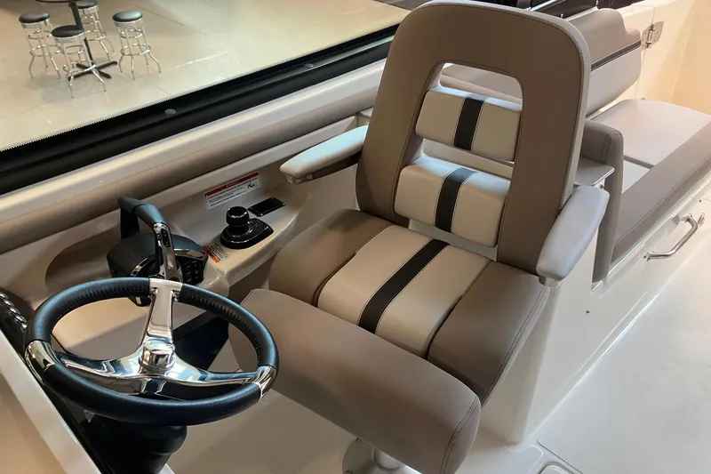 Slide: The Image of Captain's seat and steering wheel of 2026 Boston Whaler 330 Vantage boat. - 20
