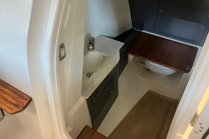 Slide: The Image of 2026 Boston Whaler 330 Vantage boat interior with sink and toilet. - 23