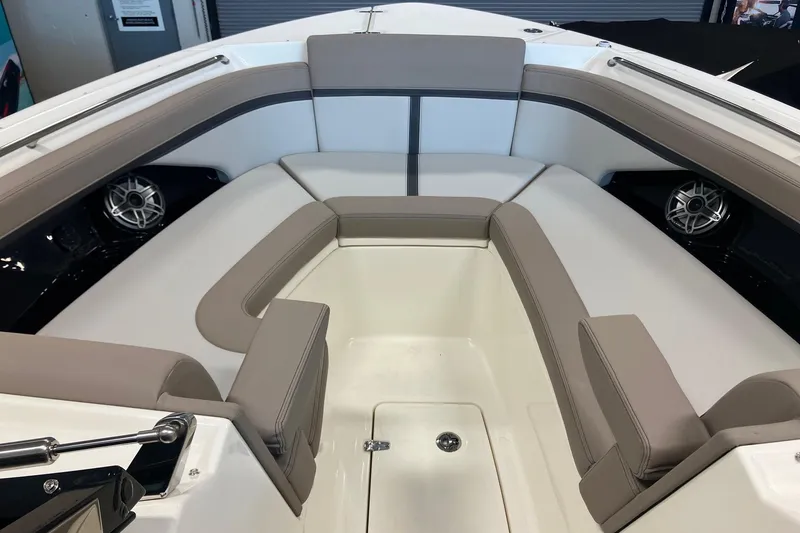 Slide: The Image of 2026 Boston Whaler 330 Vantage boat interior with cushioned seating and speakers. - 25