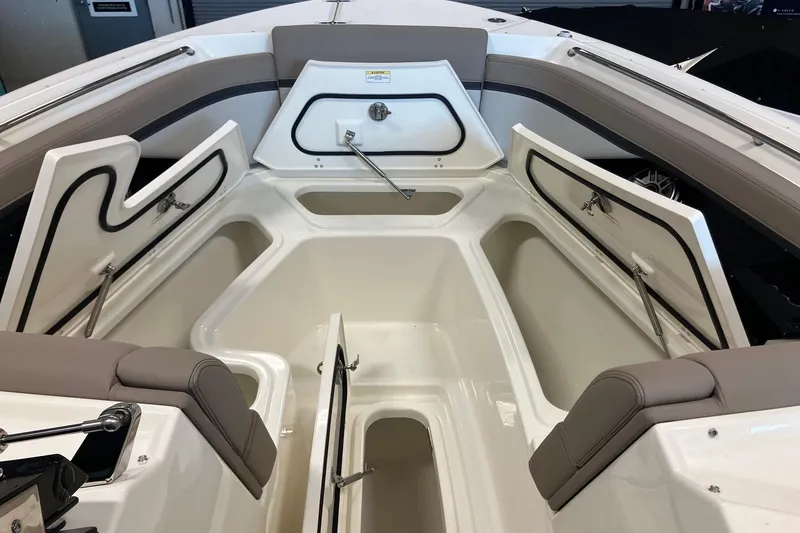 Slide: The Image of 2026 Boston Whaler 330 Vantage interior storage compartments open, showcasing spacious design. - 27