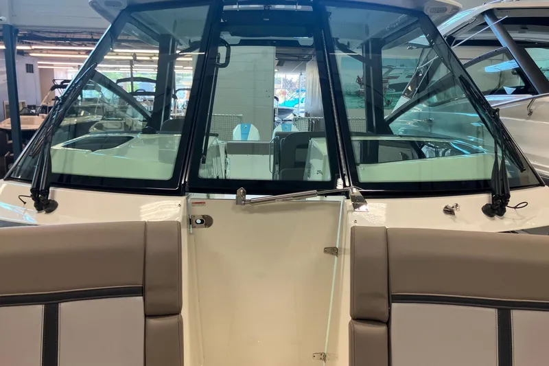 Slide: The Image of 2026 Boston Whaler 330 Vantage boat interior with windshield and seating. - 30