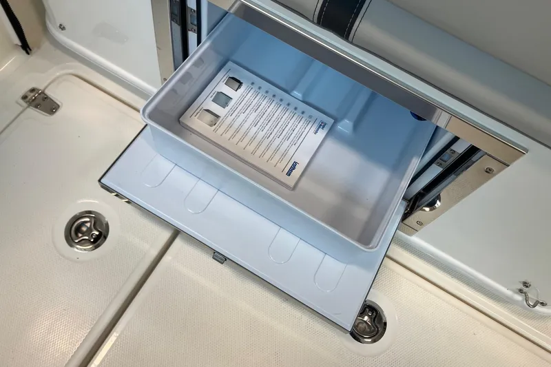 Slide: The Image of Open storage compartment on 2026 Boston Whaler 330 Vantage boat. - 8