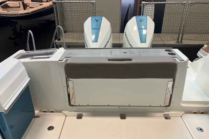 Slide: The Image of 2026 Boston Whaler 330 Vantage boat with dual Mercury engines, rear seating, and storage. - 9