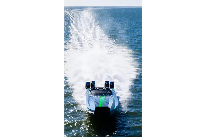 Slide: The Image of 2026 Nor-Tech 4000 Roadster speedboat cruising on open water, leaving a trail of spray. - 8