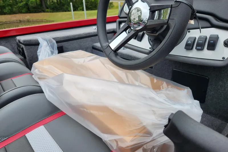 Slide: The Image of 2026 Ranger RT178 boat interior with steering wheel and wrapped package on seat. - 14