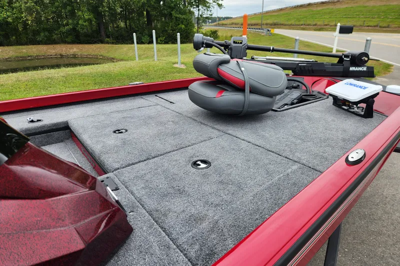 Slide: The Image of 2026 Ranger RT178 boat deck with seating and equipment, parked near a grassy area. - 9