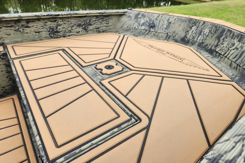 Slide: The Image of 2026 Tracker Grizzly 1650 T Prairie Wings Edition boat interior with custom deck design. - 10