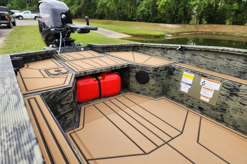 Slide: The Image of 2026 Tracker Grizzly 1650 T Prairie Wings Edition boat interior with Mercury outboard motor. - 11