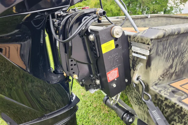 Slide: The Image of 2026 Tracker Grizzly 1650 T Prairie Wings Edition boat motor detail, showcasing engine components. - 13