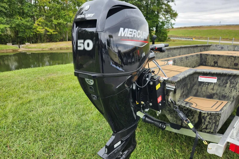 Slide: The Image of 2026 Tracker Grizzly 1650 T Prairie Wings Edition with Mercury 50 outboard motor by a lake. - 3