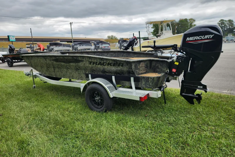 Slide: The Image of 2026 Tracker Grizzly 1650 T Prairie Wings Edition boat on trailer with Mercury outboard motor. - 4