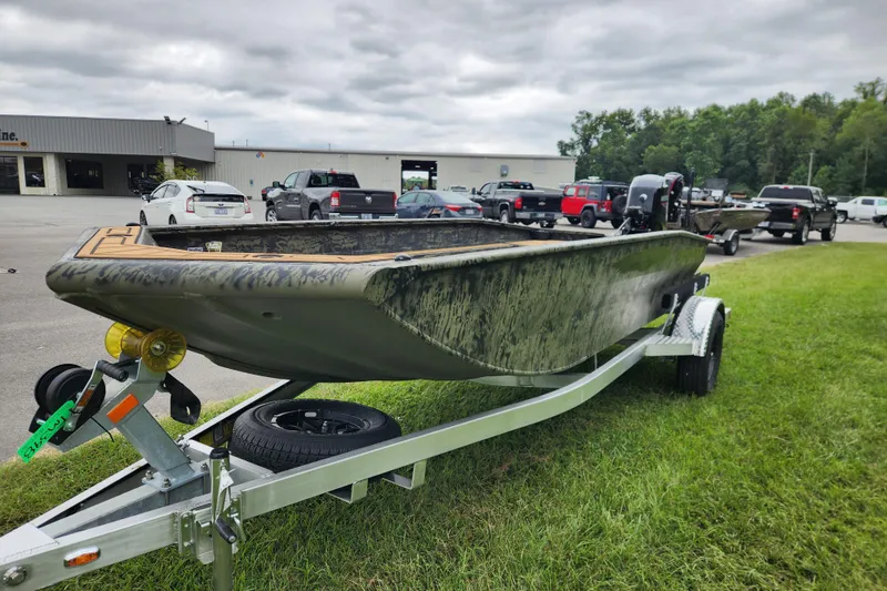 Slide: The Image of 2026 Tracker Grizzly 1650 T Prairie Wings Edition boat on trailer, parked on grass. - 6