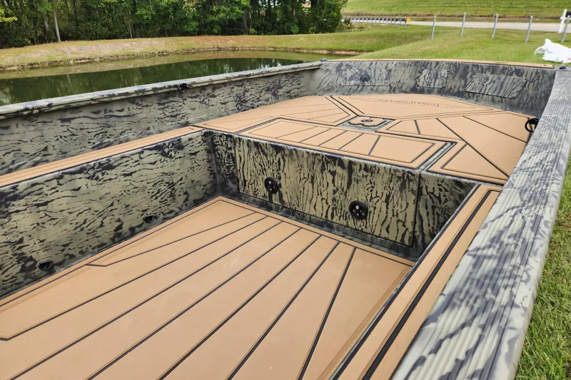 Slide: The Image of 2026 Tracker Grizzly 1650 T Prairie Wings Edition boat interior with camouflage design. - 9