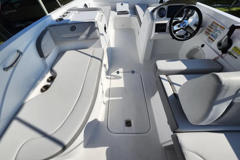 Slide: The Image of 2023 Hurricane SunDeck Sport 205 OB boat interior with seating and steering console. - 13