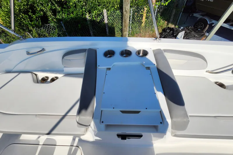 Slide: The Image of 2023 Hurricane SunDeck Sport 205 OB boat interior with seating and cup holders. - 14