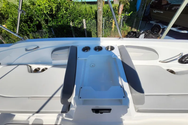Slide: The Image of 2023 Hurricane SunDeck Sport 205 OB boat interior with seating and cup holders. - 15