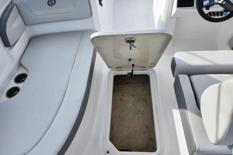 Slide: The Image of 2023 Hurricane SunDeck Sport 205 OB boat interior with open storage compartment. - 18