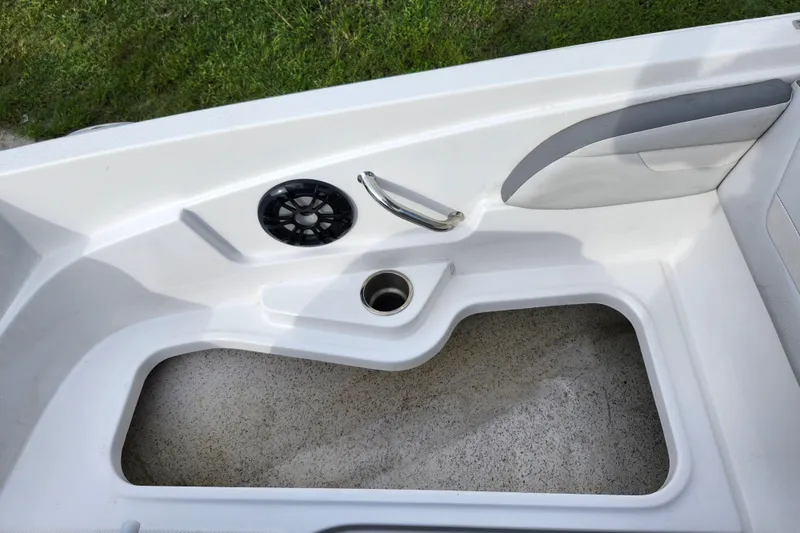 Slide: The Image of 2023 Hurricane SunDeck Sport 205 OB boat interior with speaker and cup holder. - 19