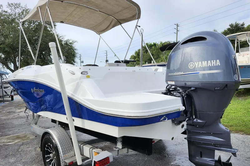 Slide: The Image of 2023 Hurricane SunDeck Sport 205 OB boat with Yamaha outboard motor on a trailer. - 22