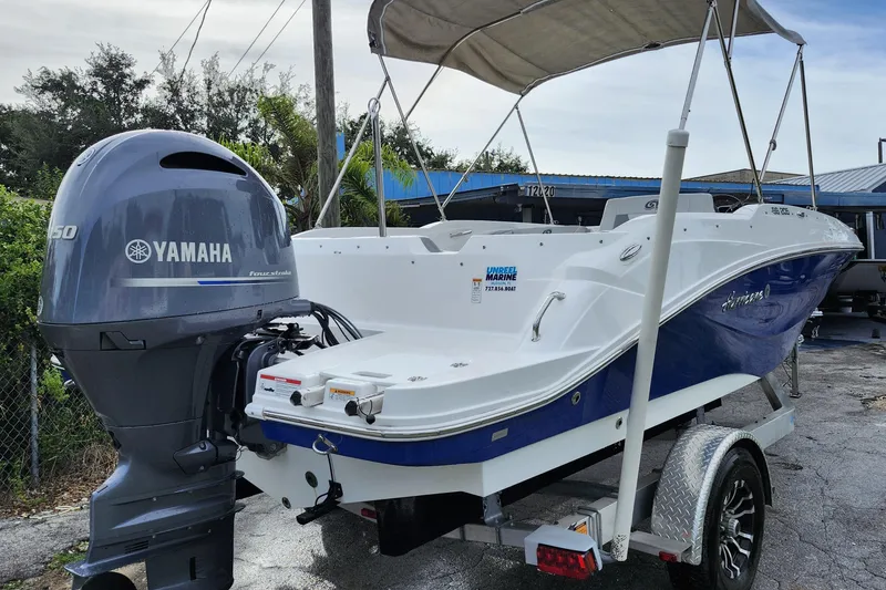 Slide: The Image of 2023 Hurricane SunDeck Sport 205 OB boat with Yamaha engine on trailer. - 23