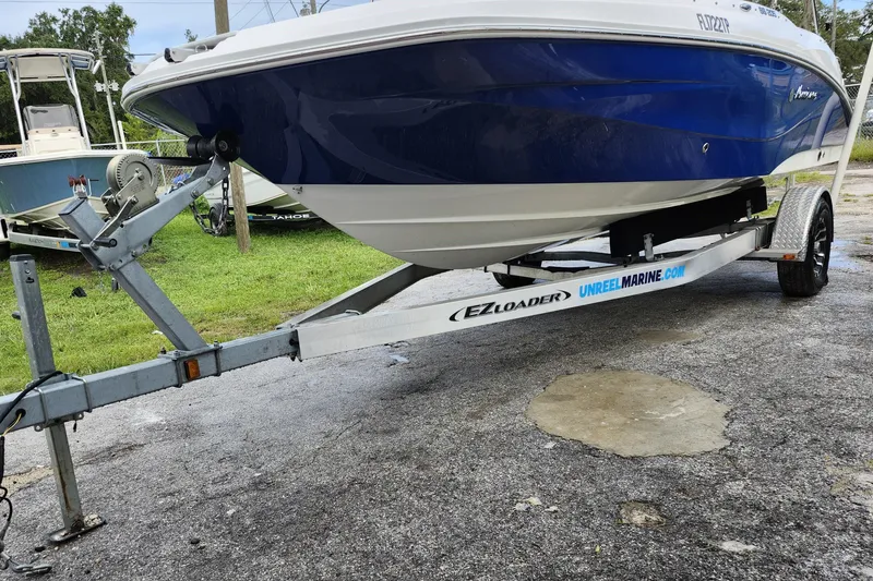Slide: The Image of 2023 Hurricane SunDeck Sport 205 OB boat on EZ Loader trailer, parked outdoors. - 26