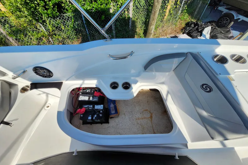 Slide: The Image of 2023 Hurricane SunDeck Sport 205 OB boat interior with seating, cup holders, and battery compartment. - 7