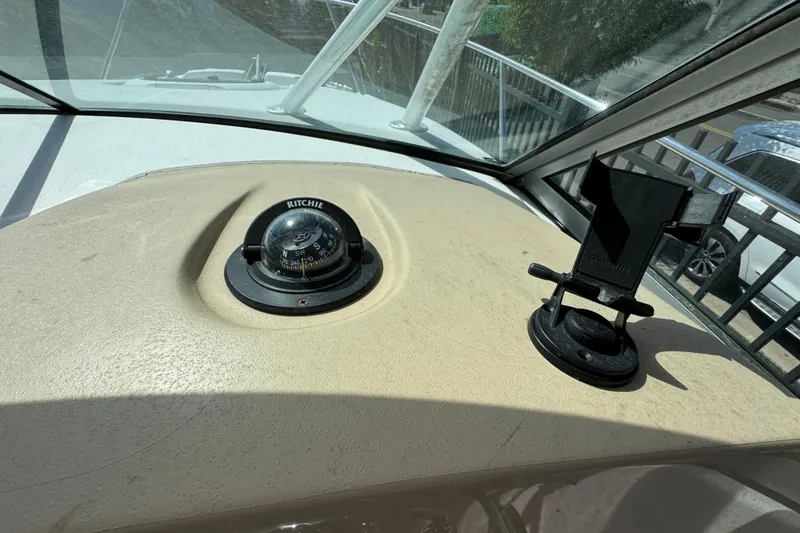 Slide: The Image of Dashboard of a 2012 Wellcraft 210 Coastal boat with compass and Garmin mount. - 12