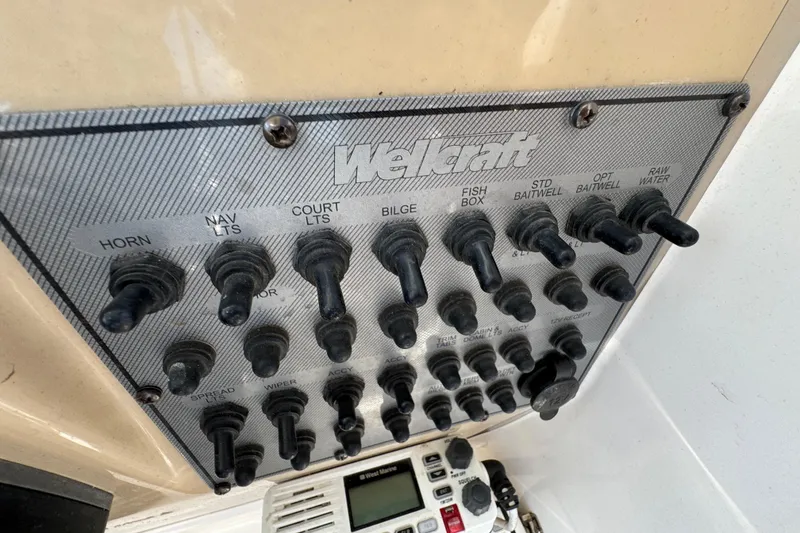 Slide: The Image of Control panel of a 2012 Wellcraft 210 Coastal boat with labeled switches. - 13