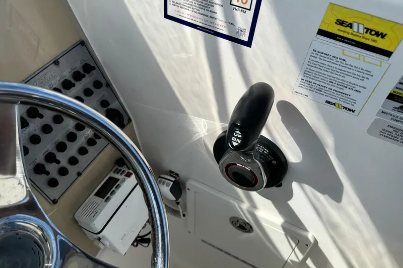 Slide: The Image of Control panel and steering wheel of a 2012 Wellcraft 210 Coastal boat. - 16