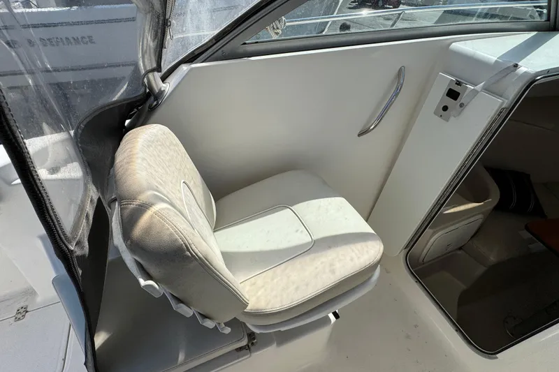 Slide: The Image of Interior of 2012 Wellcraft 210 Coastal boat showing seating and cabin entrance. - 17