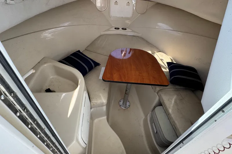 Slide: The Image of 2012 Wellcraft 210 Coastal cabin interior with table and seating. - 18