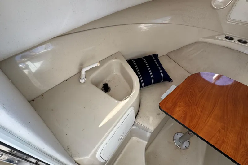Slide: The Image of Interior of 2012 Wellcraft 210 Coastal boat with sink, table, and cushion. - 19