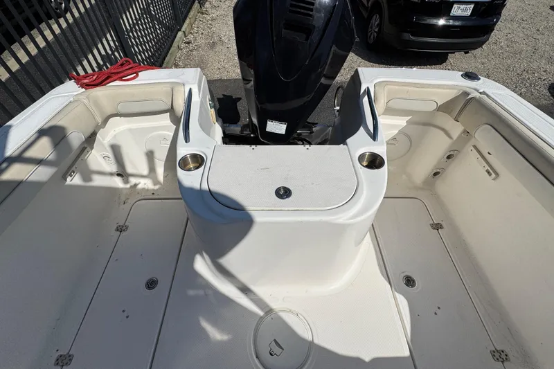 Slide: The Image of 2012 Wellcraft 210 Coastal boat interior with seating and engine view. - 3