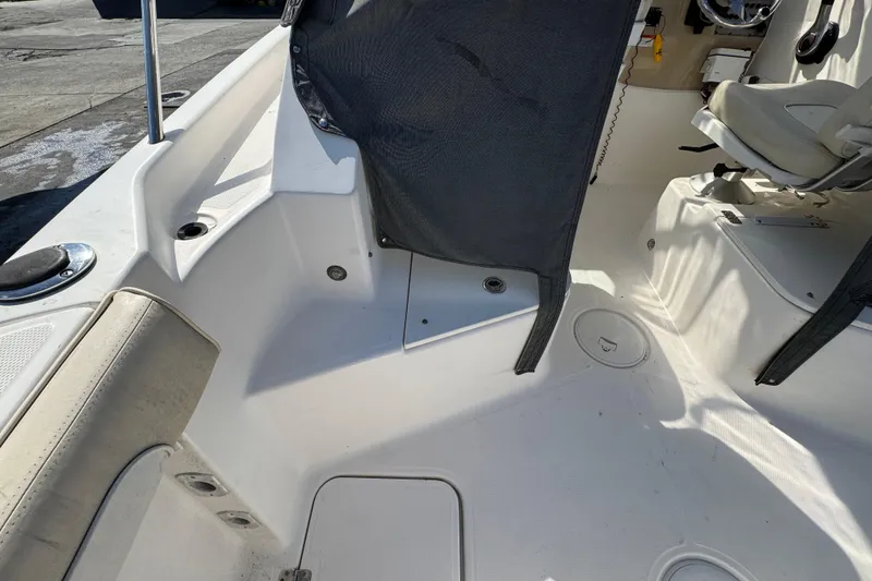 Slide: The Image of 2012 Wellcraft 210 Coastal boat interior, featuring seating and storage areas. - 7