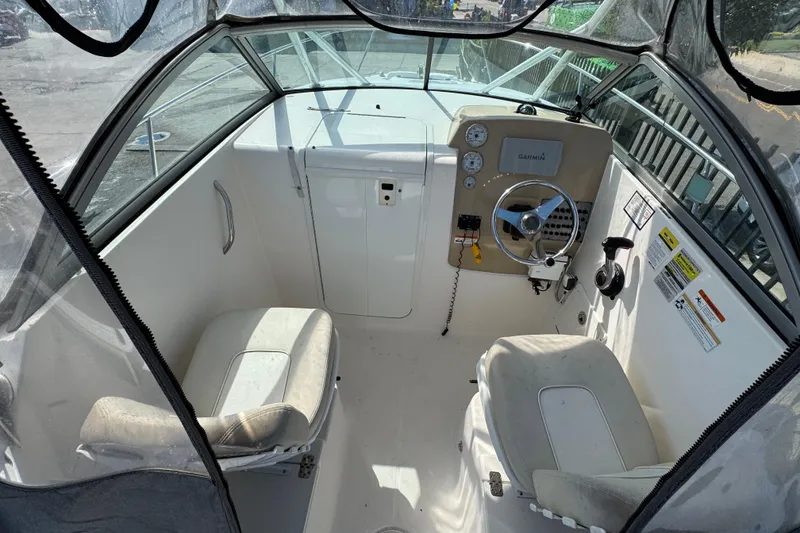Slide: The Image of Interior view of 2012 Wellcraft 210 Coastal boat cockpit with steering wheel and seating. - 9
