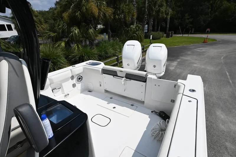 Slide: The Image of 2020 Tidewater 320 CC Adventure boat on trailer, surrounded by palm trees. - 10