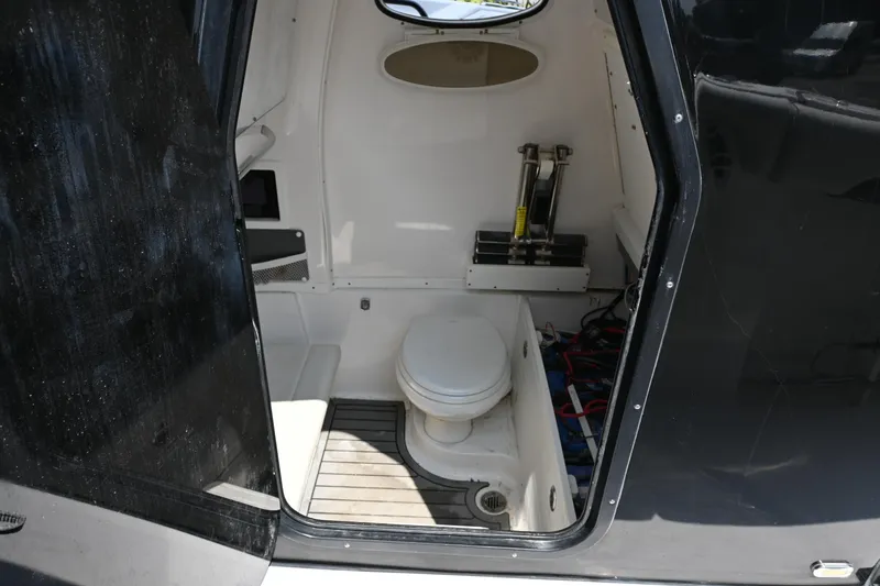 Slide: The Image of 2020 Tidewater 320 CC Adventure boat interior with compact marine toilet. - 22