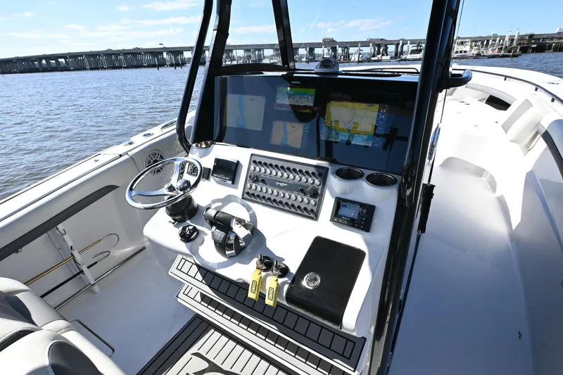 Slide: The Image of 2020 Tidewater 320 CC Adventure boat cockpit with navigation screens and controls. - 24