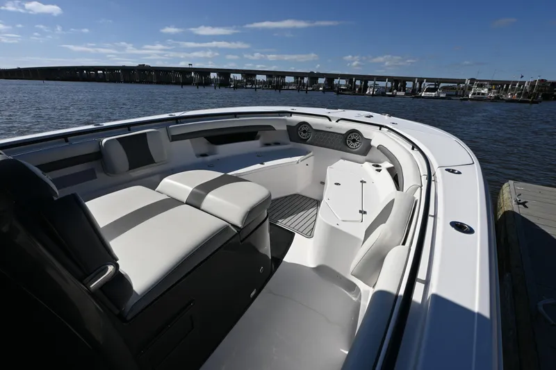 Slide: The Image of 2020 Tidewater 320 CC Adventure boat interior with seating, docked by the water. - 25