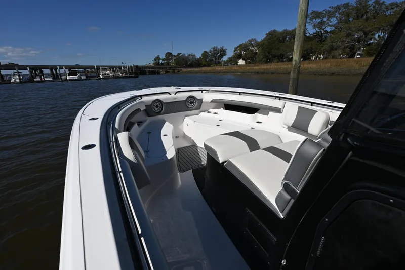 Slide: The Image of 2020 Tidewater 320 CC Adventure boat interior with white seating and open water view. - 26