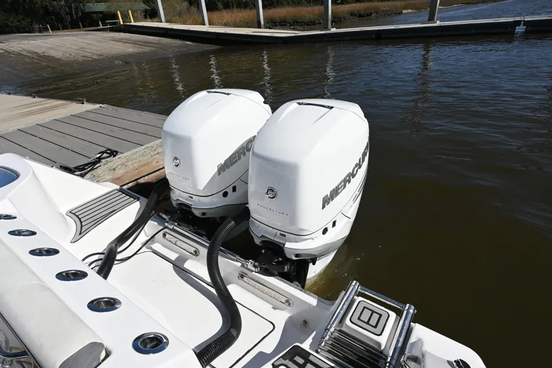 Slide: The Image of Twin Mercury outboard engines on a 2020 Tidewater 320 CC Adventure boat at a dock. - 27