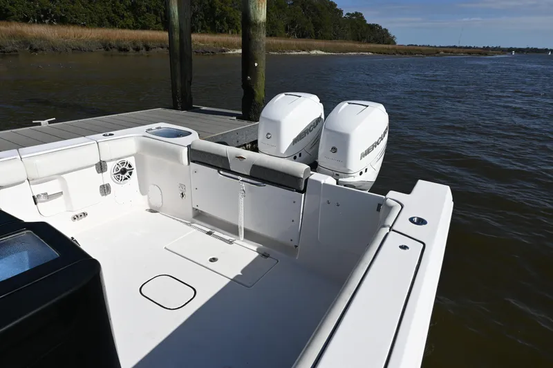Slide: The Image of 2020 Tidewater 320 CC Adventure boat with dual Mercury engines docked by the water. - 31