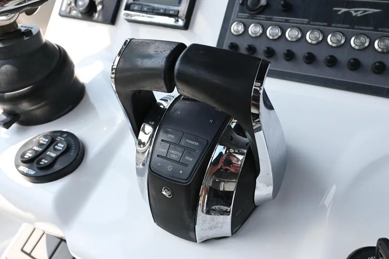 Slide: The Image of 2020 Tidewater 320 CC Adventure boat on water with dual engines. - 5