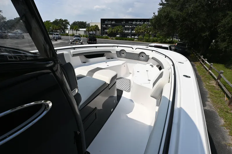 Slide: The Image of 2020 Tidewater 320 CC Adventure boat on calm water, featuring dual Mercury engines. - 6