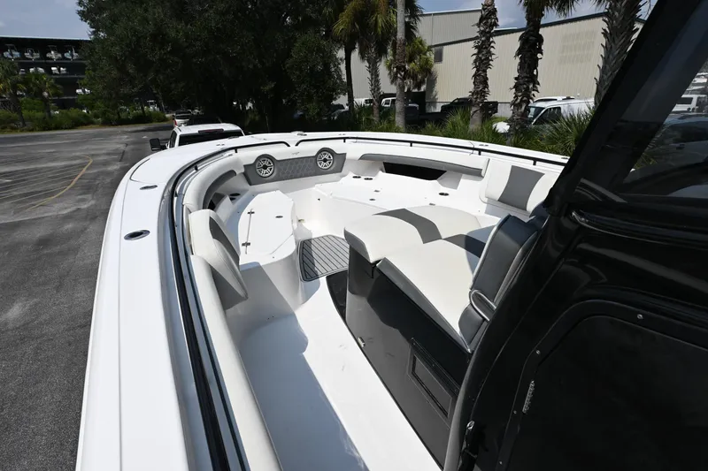 Slide: The Image of 2020 Tidewater 320 CC Adventure boat on trailer, surrounded by palm trees. - 7