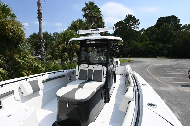 Slide: The Image of 2020 Tidewater 320 CC Adventure boat on trailer, featuring dual Mercury engines. - 8