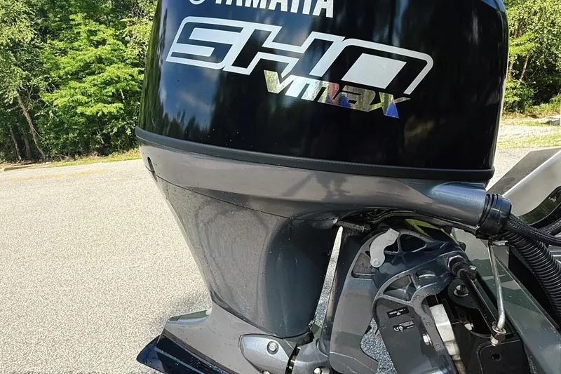 Slide: The Image of 2024 Reaper Boats 550 with Yamaha engine on a calm river. - 11